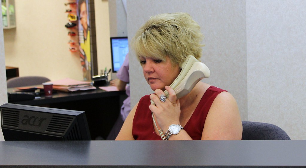 Receptionist answering the phone at a medical clinic